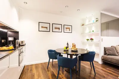 a kitchen and dining room with a table and chairs at LE MAY AP4338 By Riviera Holiday Homes in Villefranche-sur-Mer