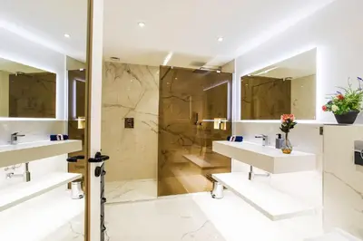 a bathroom with two sinks and a shower at LE MAY AP4338 By Riviera Holiday Homes in Villefranche-sur-Mer