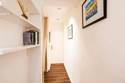 a hallway with white walls and wooden floors at LE MAY AP4338 By Riviera Holiday Homes in Villefranche-sur-Mer