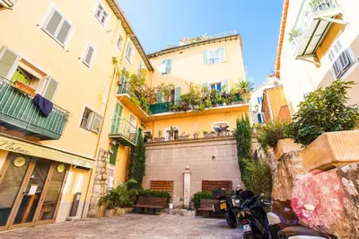 a motorcycle parked in front of some buildings at LE MAY AP4338 By Riviera Holiday Homes in Villefranche-sur-Mer