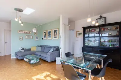 a living room with a couch and a glass table at Beautiful villa with panoramic view over Nice in Nice