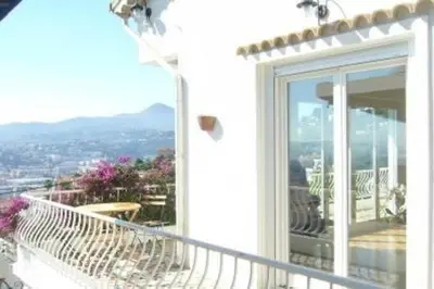 a balcony with a white railing and a window at Beautiful villa with panoramic view over Nice in Nice
