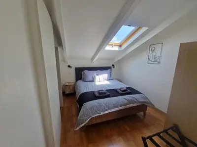 a bedroom with a bed with two towels on it at Le Michelangelo - Place Masséna in Nice