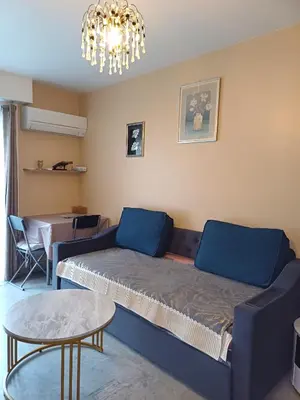 a living room with a couch and a table at Elegant F1 proche tramway et plage in Nice