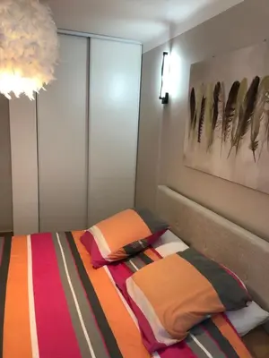 a bedroom with a bed and a painting on the wall at Appart Nice Marguerite in Nice