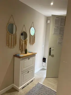 a room with a dresser and two mirrors and a door at Appart Nice Marguerite in Nice