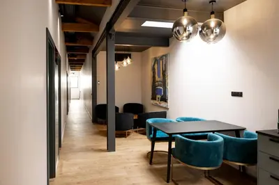 a dining room with a table and blue chairs at Centrum Nice in Nice