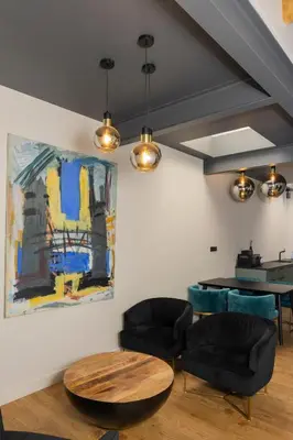 a room with two chairs and a table and a painting at Centrum Nice in Nice