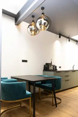 a dining room with a table and blue chairs at Centrum Nice in Nice