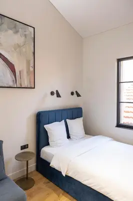 a bedroom with a blue bed and a table at Centrum Nice in Nice