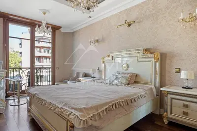 a bedroom with a large bed and a chandelier at Luxury apartment with sea view on the first line Promenade des Anglais in Nice