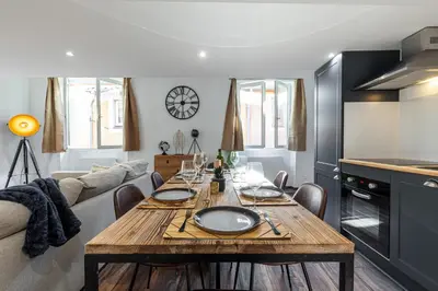 a dining room with a table and a couch at Spacious 2 Bdr Old Town Heart in Nice