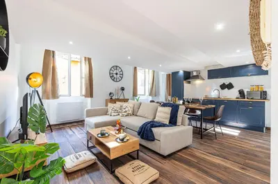 a living room with a couch and a table at Spacious 2 Bdr Old Town Heart in Nice