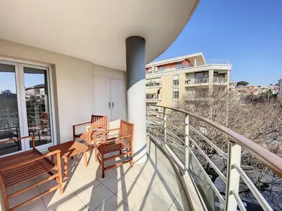 a balcony with two benches and a view of a building at A303- Appartement 3 pieces 4 personnes- Le Crystal in Cagnes-sur-Mer