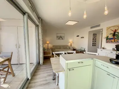 a kitchen and living room with a couch and a table at A303- Appartement 3 pieces 4 personnes- Le Crystal in Cagnes-sur-Mer