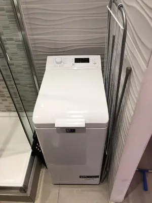 a white refrigerator sitting on a shelf in a room at Charmant studio à Cros de Cagnes in Cagnes-sur-Mer