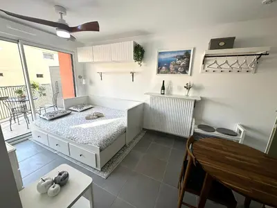 a white room with a bed and a balcony at Charmant Studio à proximité du Port de Nice in Nice