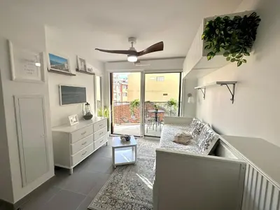 a living room with a couch and a dresser at Charmant Studio à proximité du Port de Nice in Nice