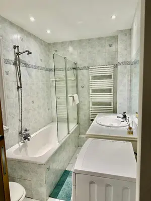 a bathroom with a tub and a toilet and a sink at Negresco Residence Apartment with AC Promenade des Anglais in Nice