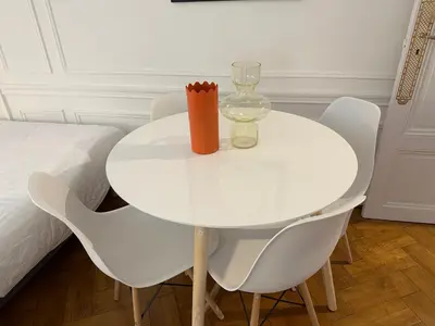 a white dining room table with chairs and a glass at Negresco Residence Apartment with AC Promenade des Anglais in Nice