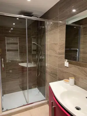 a bathroom with a glass shower and a sink at Nice Proche mer Climatisé 2 pièces style loft in Nice