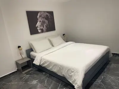 a bedroom with a bed with a lion picture on the wall at Nice Proche mer Climatisé 2 pièces style loft in Nice