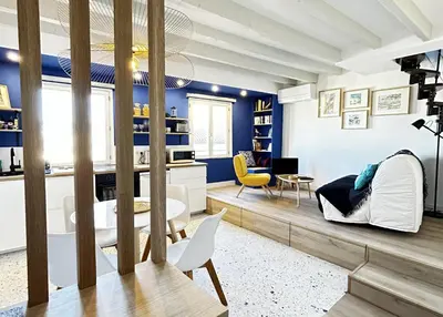 a living room with blue walls and white furniture at Nice Chateau Duplex Menica vue sur le vieux Nice in Nice