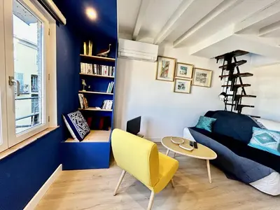 a living room with a couch and a table at Nice Chateau Duplex Menica vue sur le vieux Nice in Nice