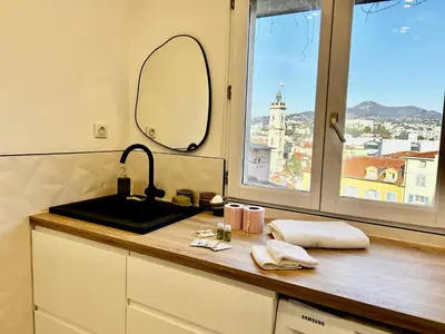 a bathroom counter with a sink and a mirror at Nice Chateau Duplex Menica vue sur le vieux Nice in Nice