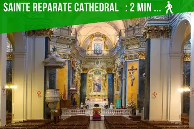 a large church with a green banner in front of it at DUPLEX LE GESÙ - VIEILLE VILLE - CLIM - WIFI in Nice