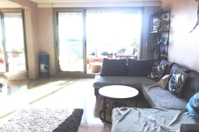 a living room with a couch and a table at Appartement Nice CENTRE vue Mer avec piscine pour FAMILLE, couple d'amis pas de groupes de jeunes autorisés in Nice