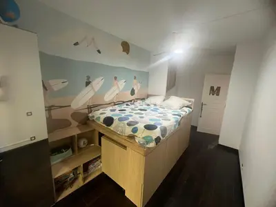 a bedroom with a bed with surfboards on the wall at Appartement Nice CENTRE vue Mer avec piscine pour FAMILLE, couple d'amis pas de groupes de jeunes autorisés in Nice