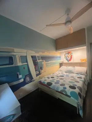 a bedroom with a bed with a van painted on the wall at Appartement Nice CENTRE vue Mer avec piscine pour FAMILLE, couple d'amis pas de groupes de jeunes autorisés in Nice