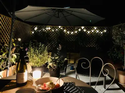 a table with a bowl of food and a bottle of wine at Charming studio mezzanine w/ large terrace - Nice in Nice