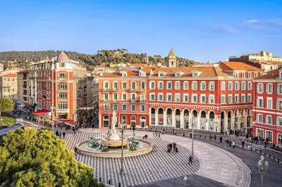 a city with a fountain in front of buildings at Charming studio mezzanine w/ large terrace - Nice in Nice