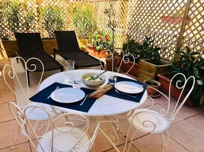 a white table with chairs and a bowl of food on it at Charming studio mezzanine w/ large terrace - Nice in Nice