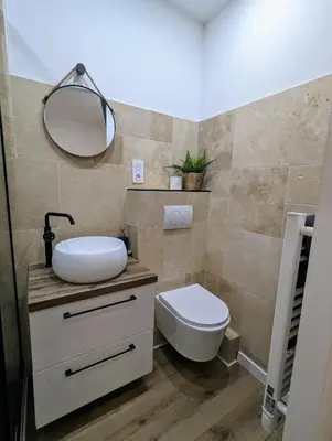 a bathroom with a toilet and a sink and a mirror at Appartement cosy proche du port in Nice