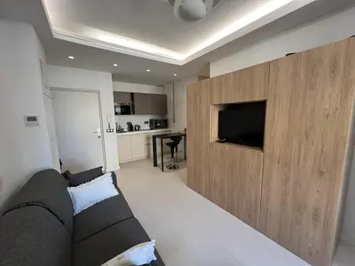 a living room with a couch and a flat screen tv at T2 Carré D'Or in Nice