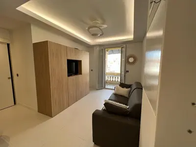 a living room with a couch and a tv at T2 Carré D'Or in Nice