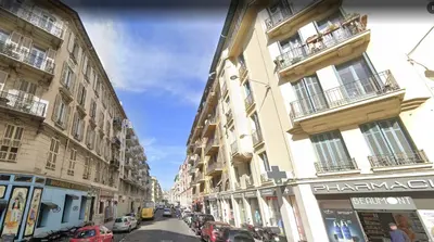 a city street with buildings and cars parked on the street at Appartamento zona porto a 10 mn a piedi dal mare in Nice