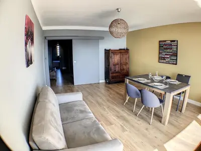 a living room with a couch and a table at Charmant 2 pièces FACE à la MER- Cagnes sur Mer in Cagnes-sur-Mer