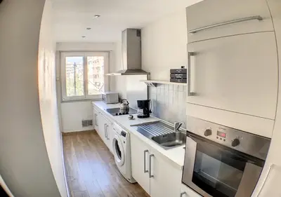 a small kitchen with a sink and a stove at Charmant 2 pièces FACE à la MER- Cagnes sur Mer in Cagnes-sur-Mer