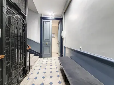 a hallway with a black door and a tiled floor at Nestor&Jeeves - LES CYPRES - central - very close sea in Nice