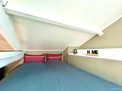 a attic room with two red pillows on a shelf at Lovely & sunny loft heart of Nice with A/C! in Nice