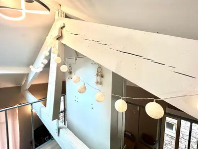 a room with a staircase with pendant lights at Lovely & sunny loft heart of Nice with A/C! in Nice