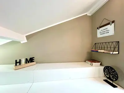 a room with a bed and a shelf on the wall at Lovely & sunny loft heart of Nice with A/C! in Nice