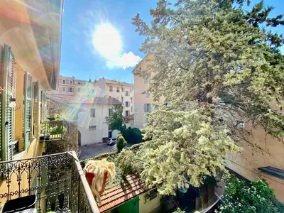 a view from a balcony of a tree and buildings at Lovely & sunny loft heart of Nice with A/C! in Nice
