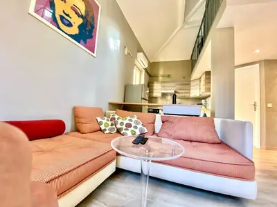 a living room with a couch and a table at Lovely & sunny loft heart of Nice with A/C! in Nice