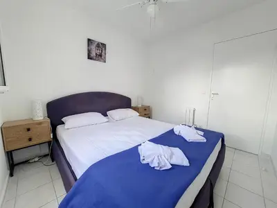 a bedroom with a bed with two towels on it at Nestor&Jeeves - VANINA - Central - Close sea in Nice