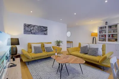 a living room with two yellow couches and a table at Maison Bianchi - Saint Philippe in Nice